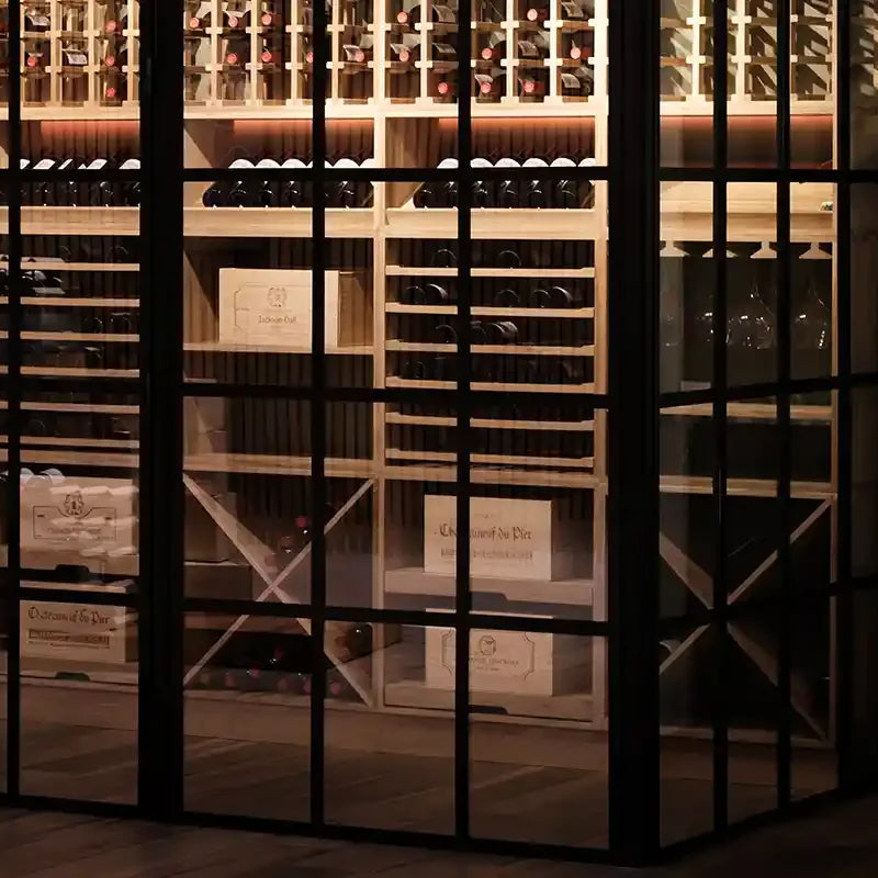 Caverack Modular Wine Rack Display behind glass walls and warm lighting